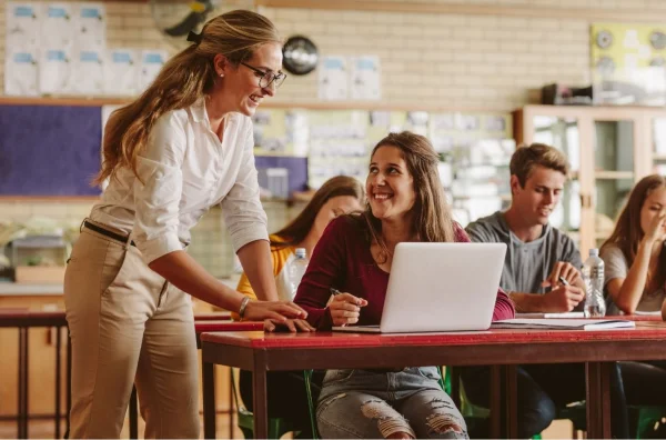 Confident teacher smiling in front of STEM classroom