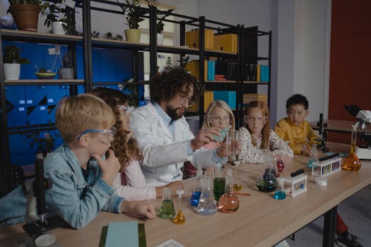 pexels-photo-5427682-5427682 Students explore chemistry experiments with a teacher guiding them in a classroom.