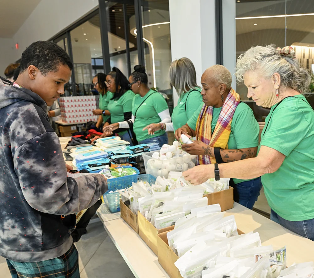Students assembling You Matter care packages for shelter residents at E-STEAM community service station